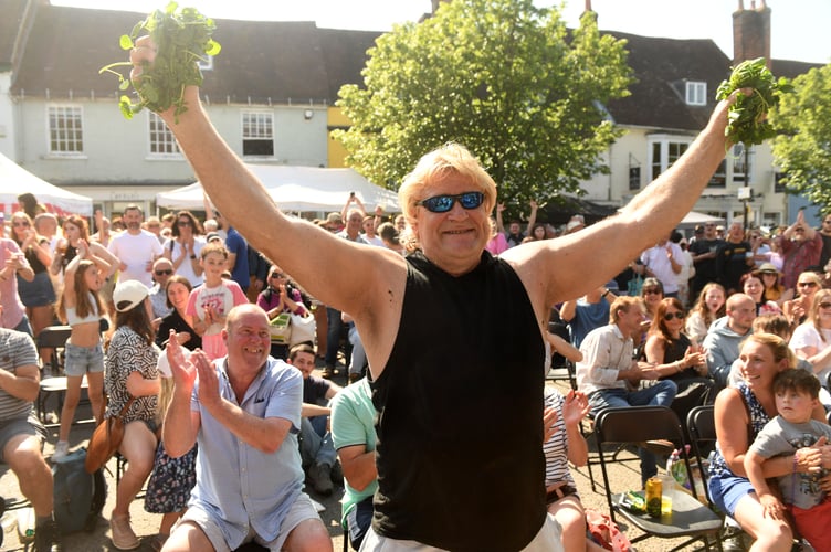 The 21st Watercress Festival took place in Alresford, Hampshire this weekend, with thousands of visitors taking to the streets of the town synonymous with producing the natural superfood, taking part in activity stalls, enjoying entertainers and musicians as well as take in the cooking expertise of professional chefs at the annual event.
Pictured: Champion Glenn Walsh celebrates his retention of the World Title of The annual Watercress eating competition..©Russell Sach - 0771 882 6138